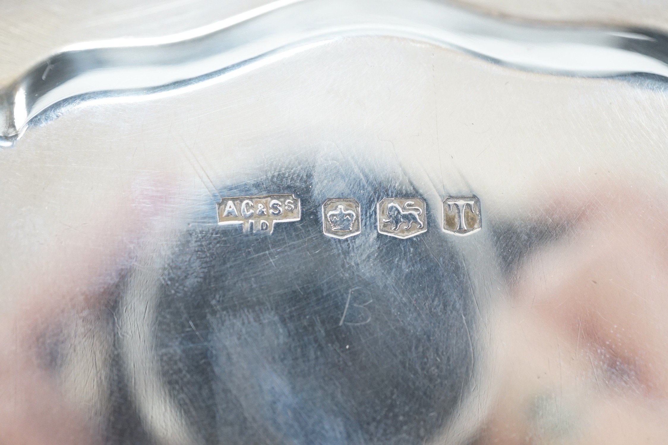 An Elizabeth II silver salver, on three scroll feet, A. Chick & Sons, Sheffield, 1961, diameter 20.3cm, 10.4oz.